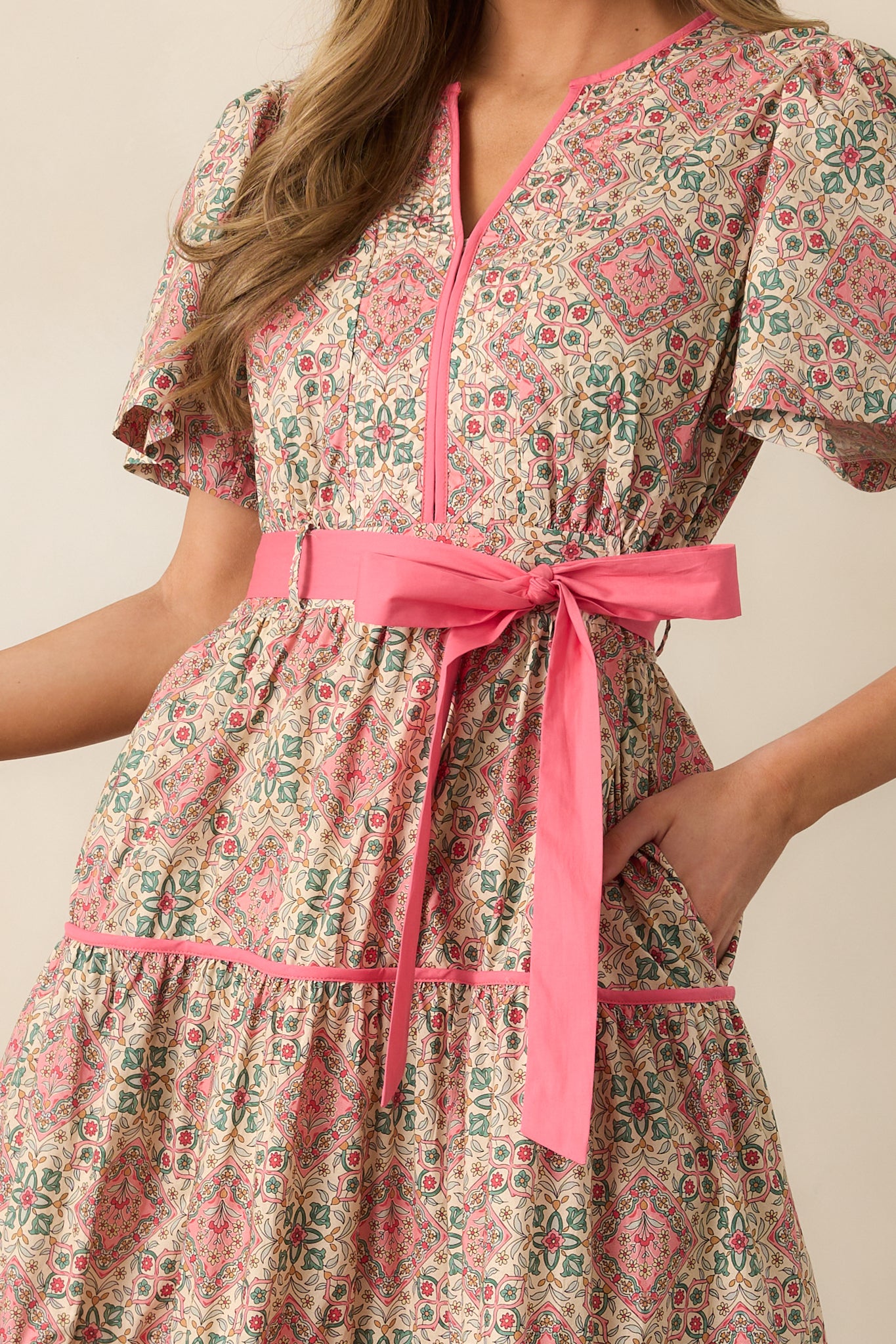 A zoomed-in view of the geometric floral print, highlighting the intricate details of the fabric and the notch v-neckline.