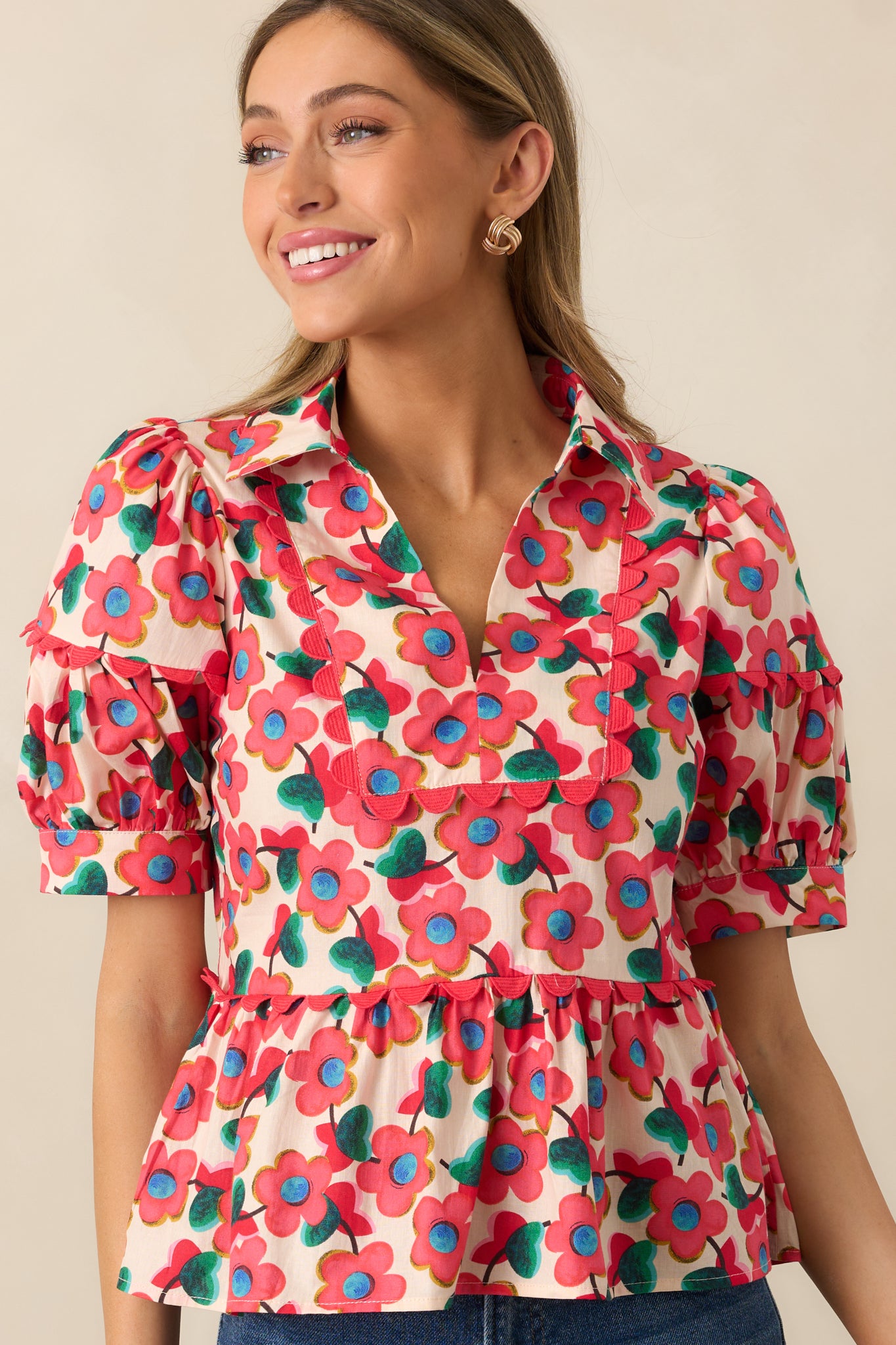 A midsection view of the red top, emphasizing the peplum silhouette and decorative ric rac detailing.