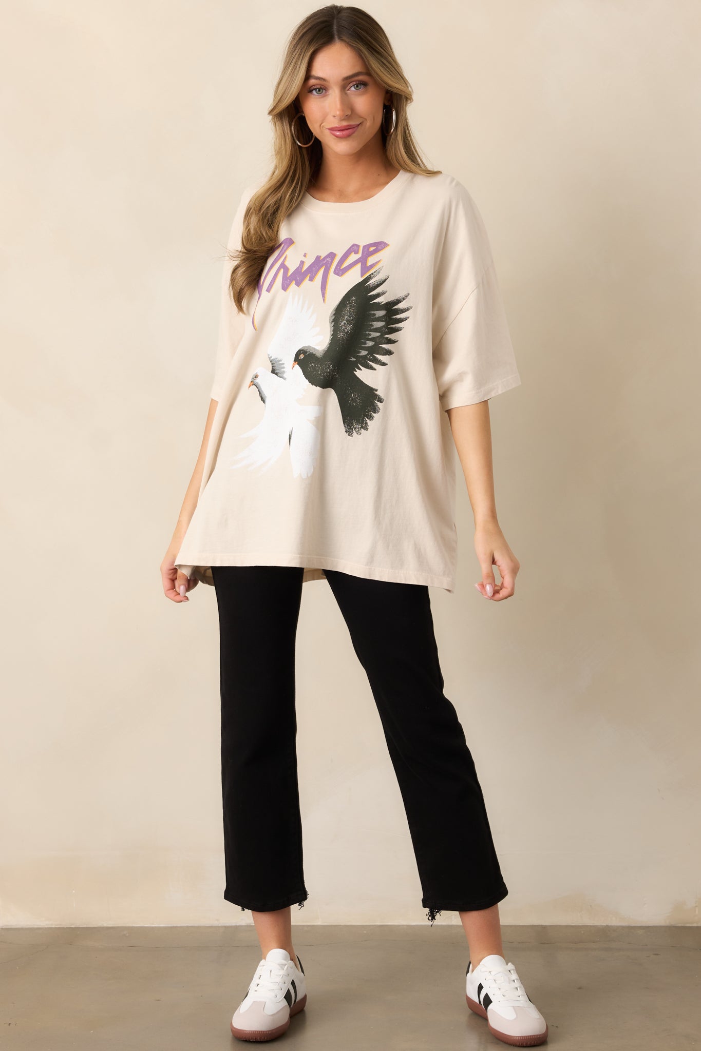 A loose-fitting ivory T-shirt featuring an authentic 1984 world tour design with bold graphic details.