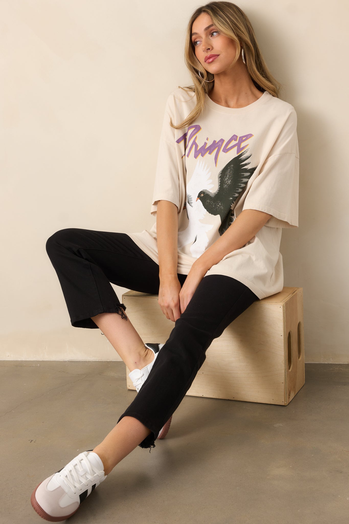 An ivory tee with a relaxed oversized fit, short sleeves, and a vintage double dove graphic on the front.