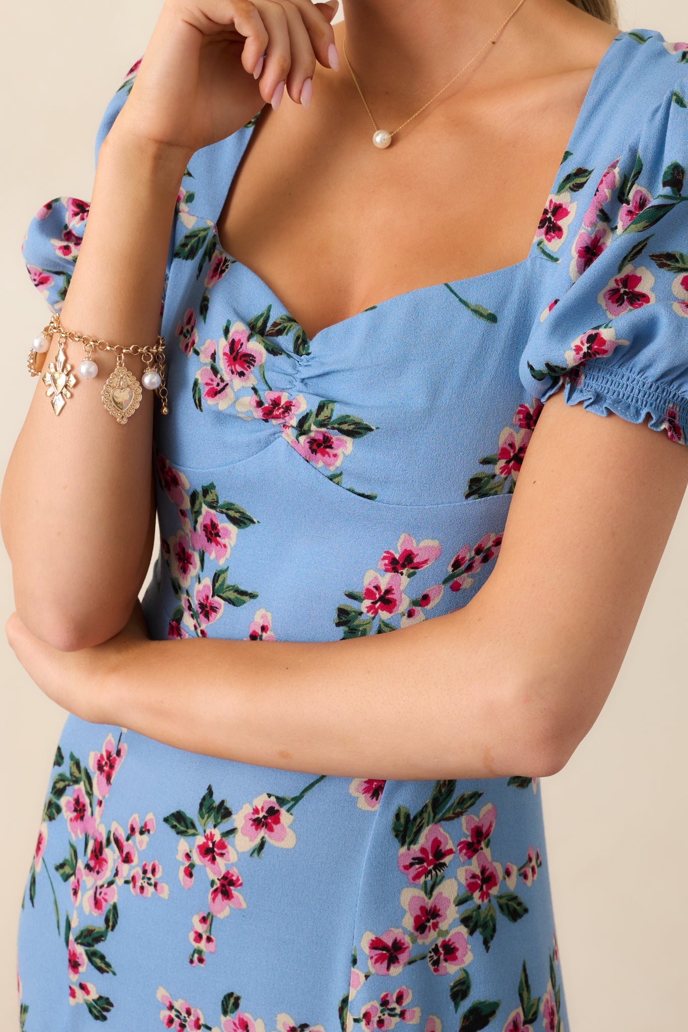 A closer look at the delicate puff sleeve detail, sweetheart neckline, and soft ash blue fabric of this elegant dress.