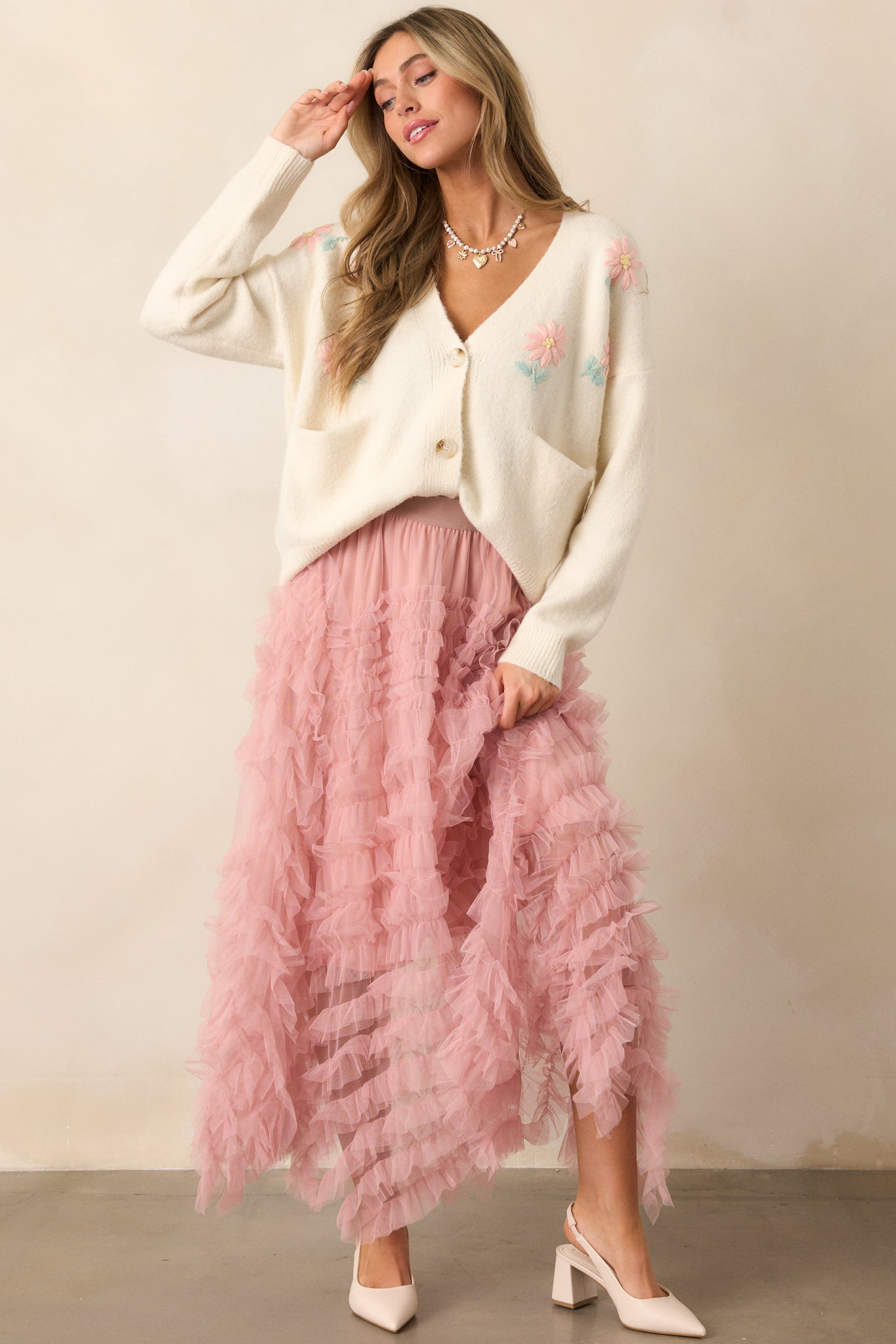 A full view of the rose midi skirt, showcasing its sheer ruffle tulle overlay and flowy silhouette.