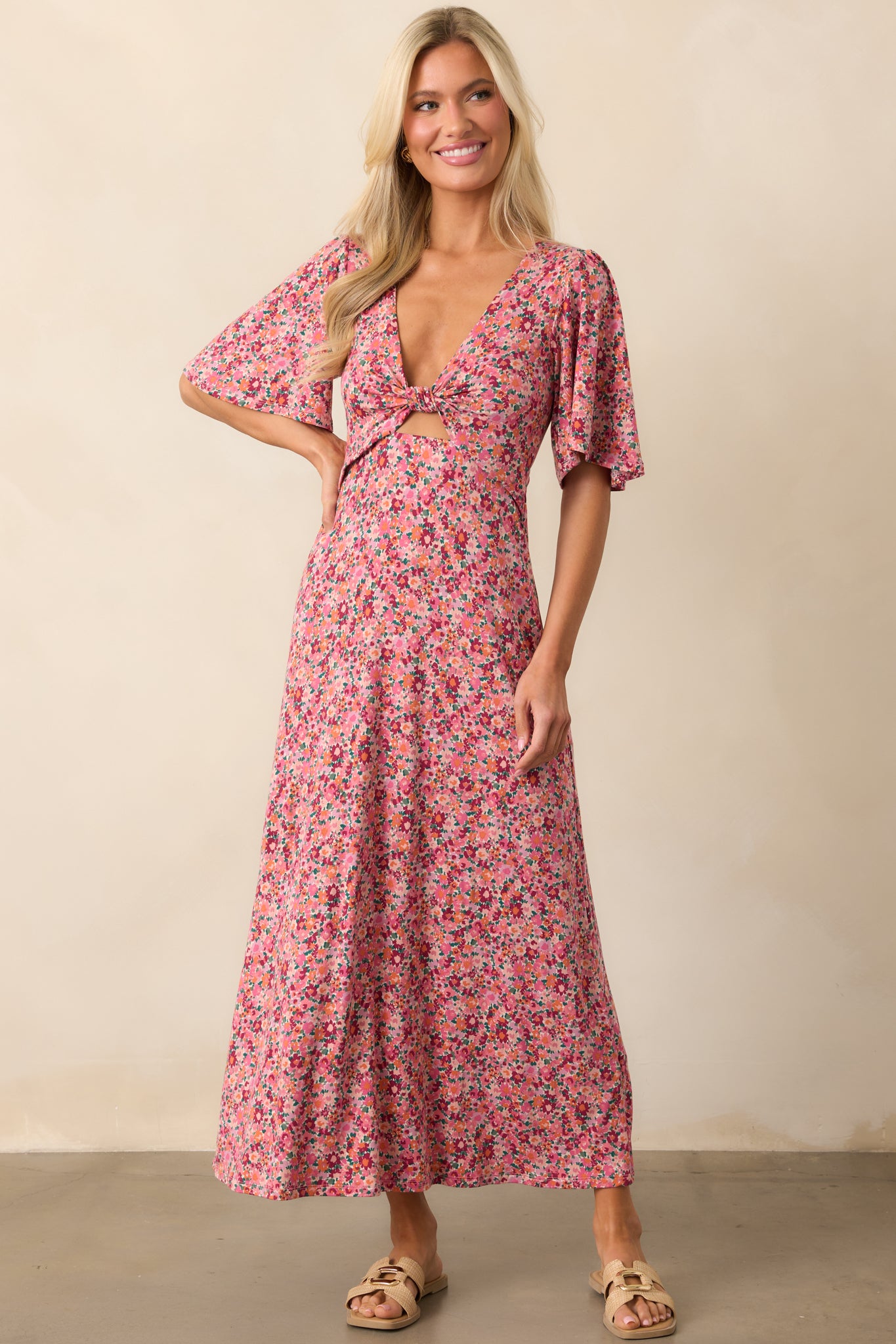 A casual yet flattering rose mauve dress with a knotted tie v-neckline, cutout below the bust, and short sleeves, designed in a soft, stretchy fabric.