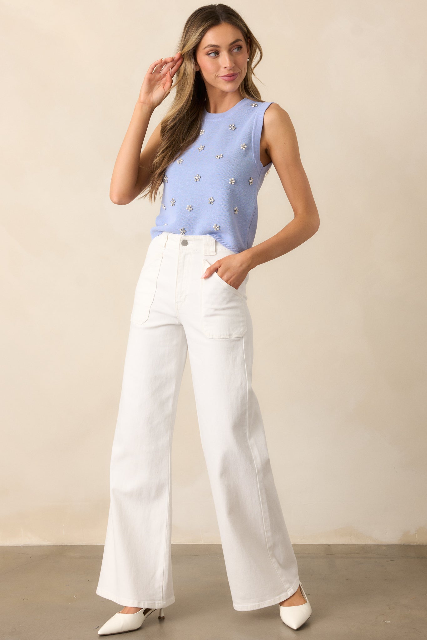 These white jeans feature a high waisted design, classic button &amp; zipper closure, belt loops, functional front patch pockets, and a flare leg.