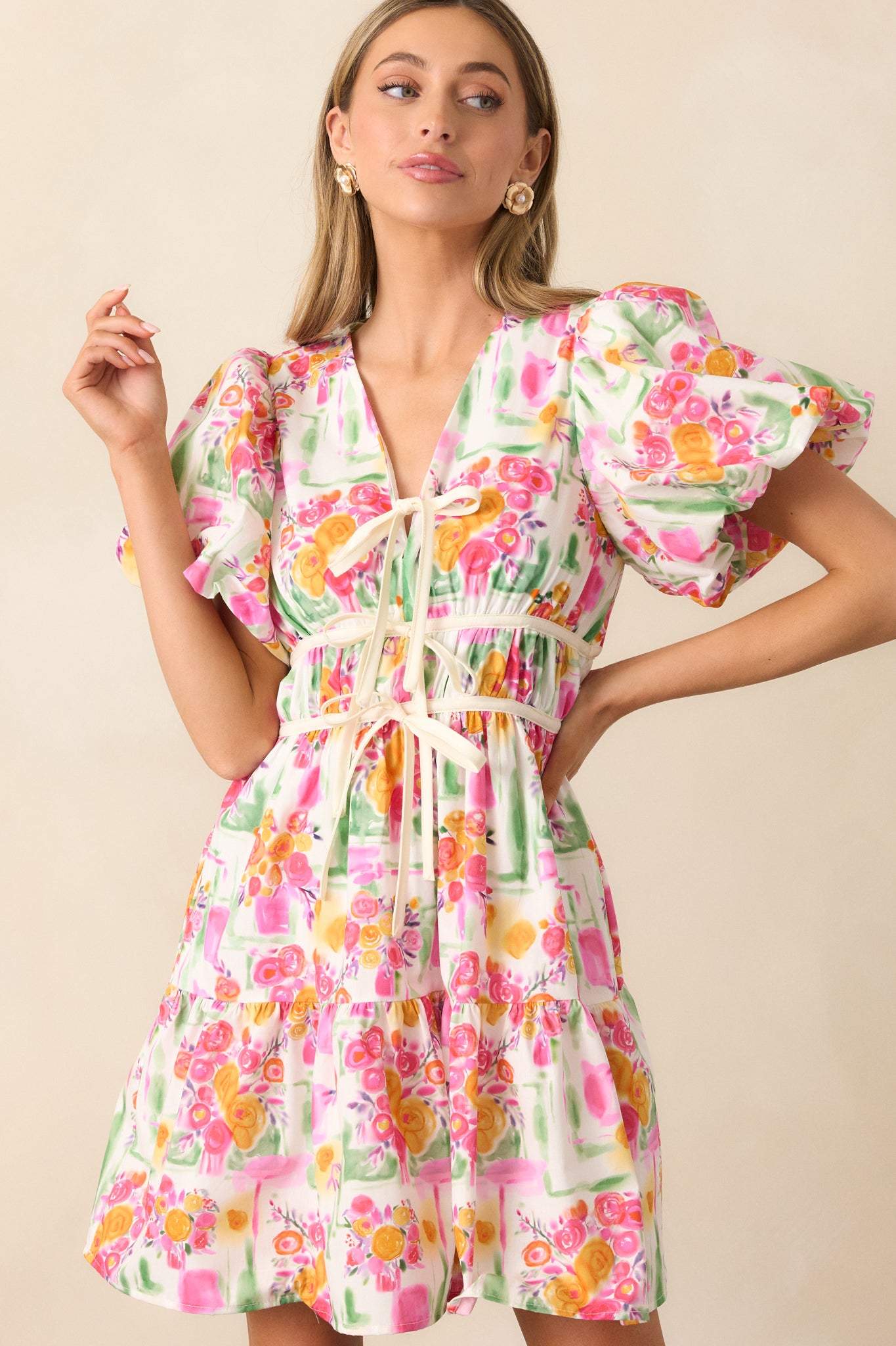 A close-up of the v-neckline and self-tie bow detail, showcasing the delicate design and feminine touch.