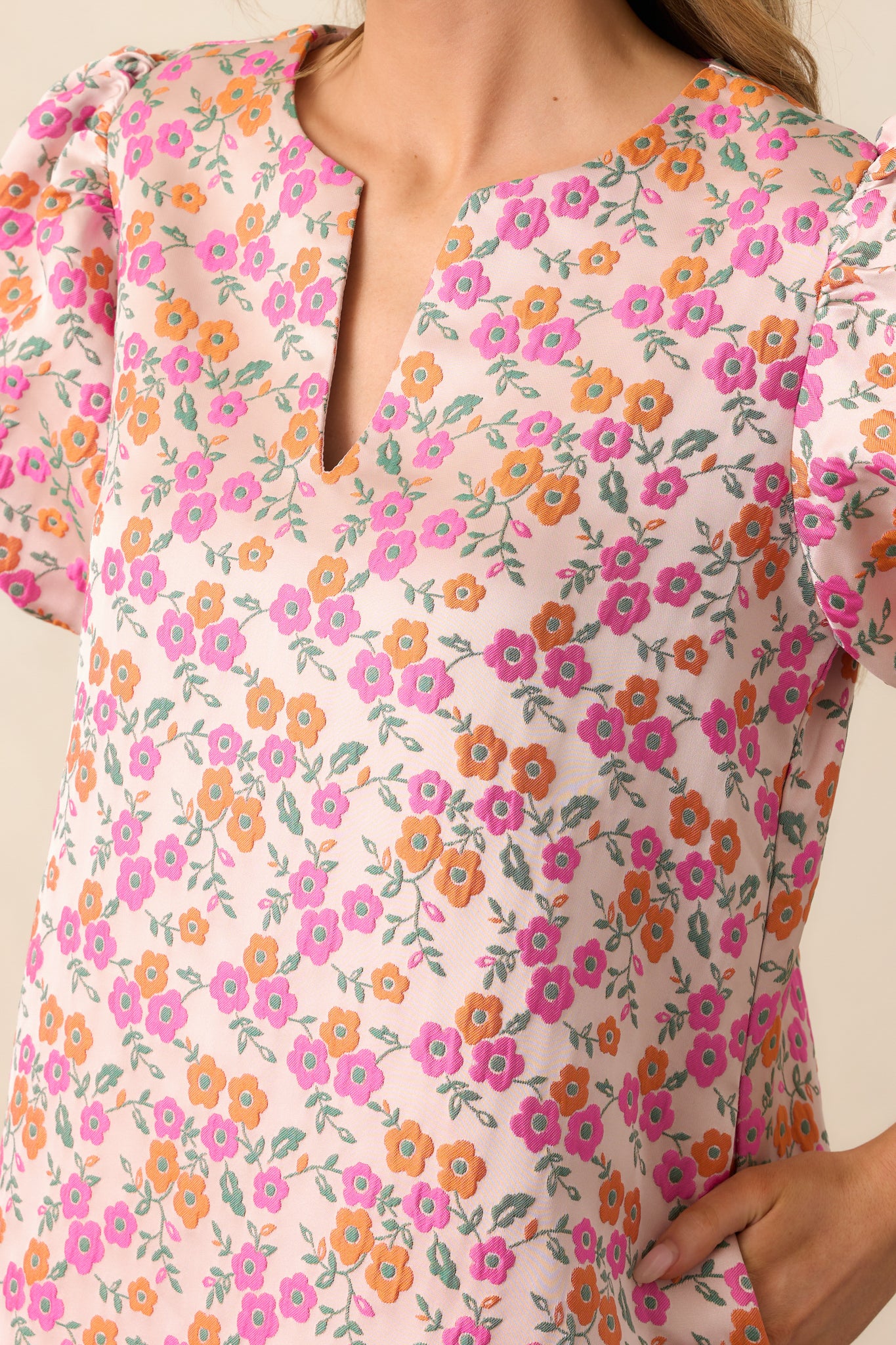 A zoomed-in view of the floral pattern details and the dress’s functional pockets, seamlessly integrated into the design for convenience and style.
