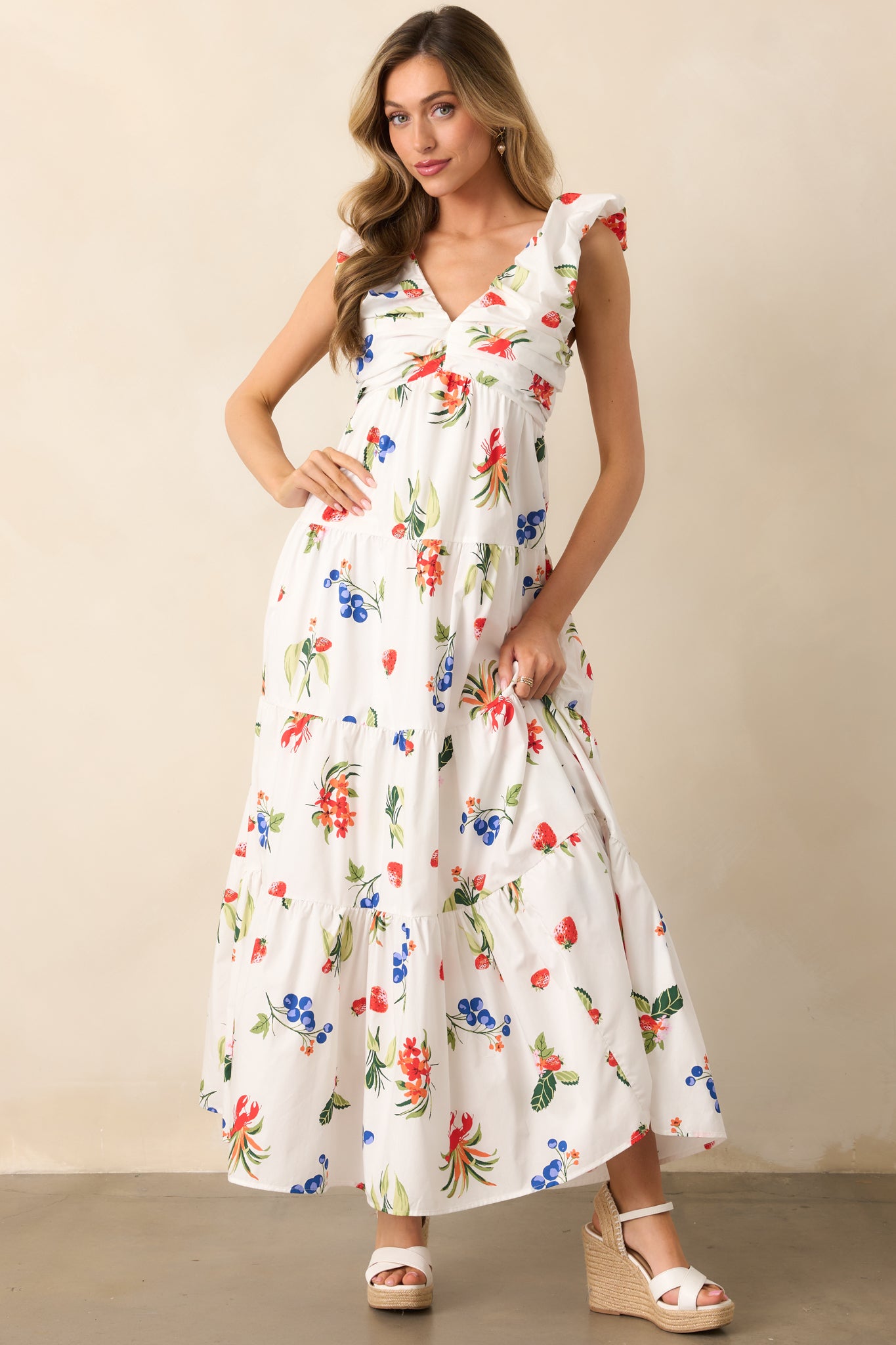 Delicate pleating and a graceful v-neckline define this white dress, paired with a flowing skirt for movement.