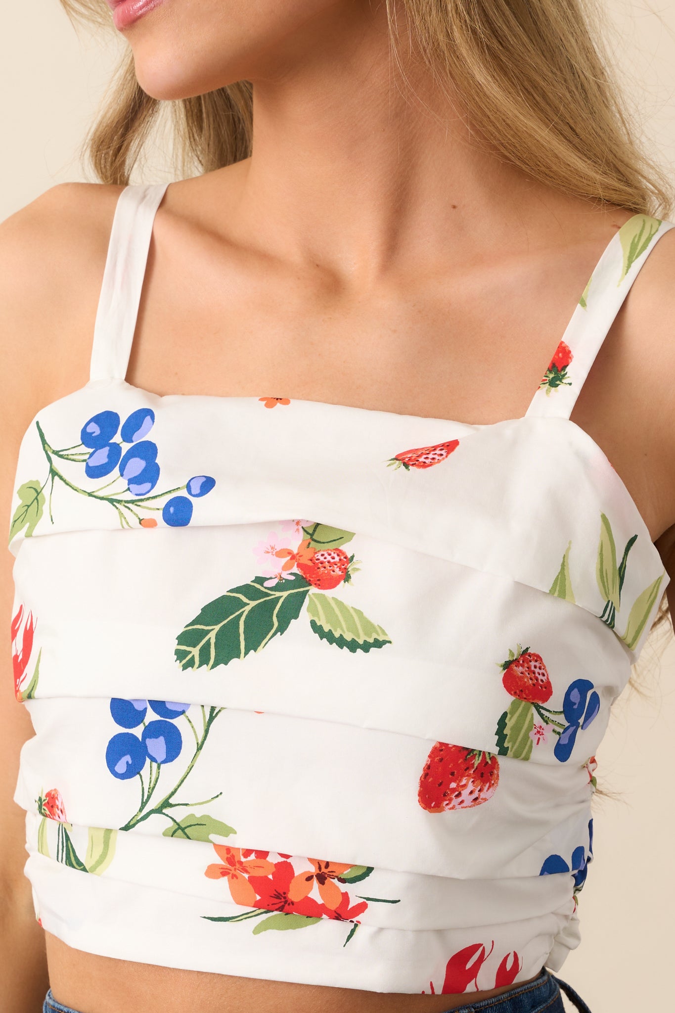 The pleated texture of the top, with a focus on the square neckline and adjustable straps for a tailored, versatile fit.