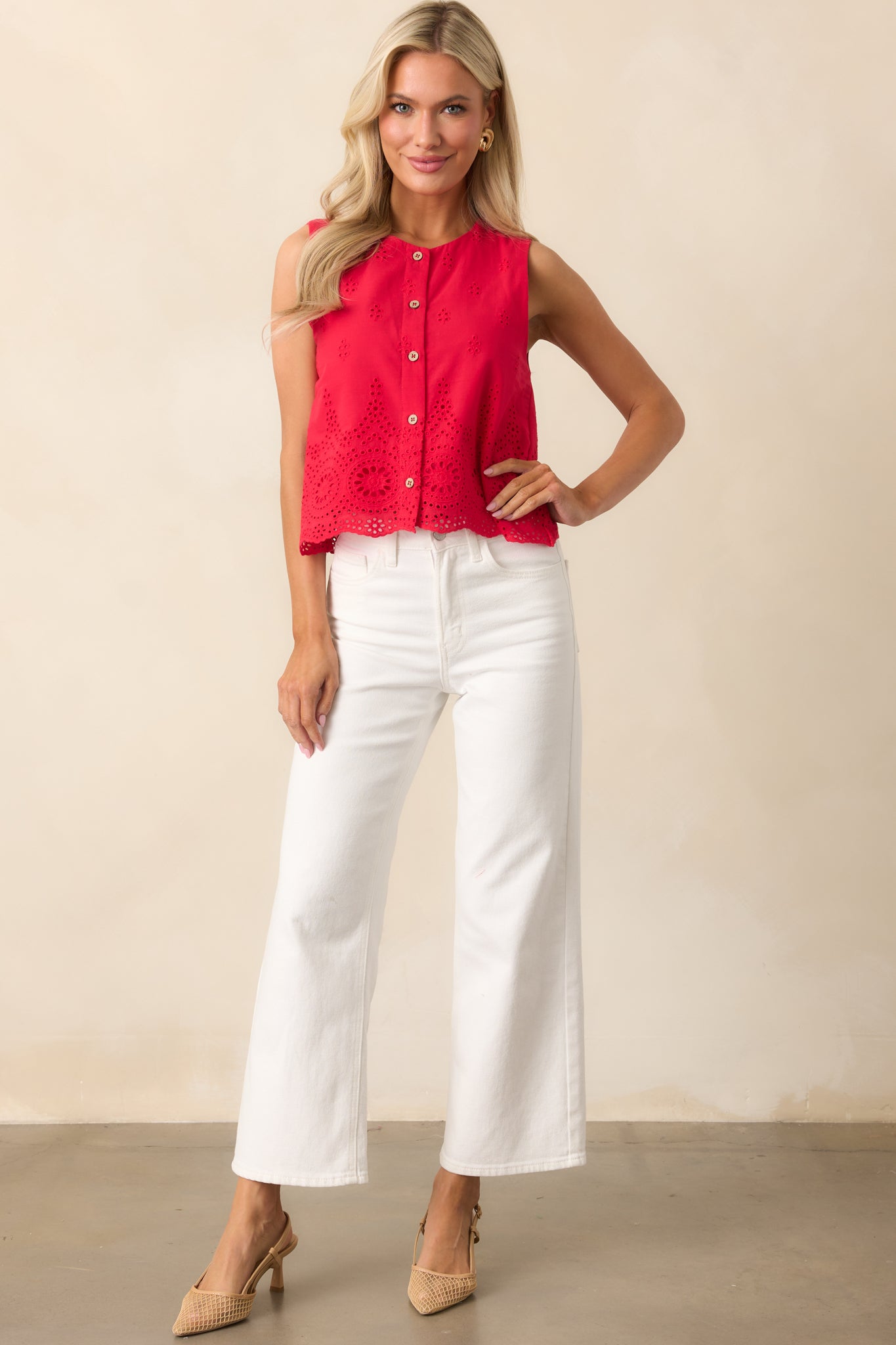 A pair of white jeans with a high-waisted silhouette, detailed with belt loops, front and back pockets, and a sleek cropped length that pairs well with any outfit.