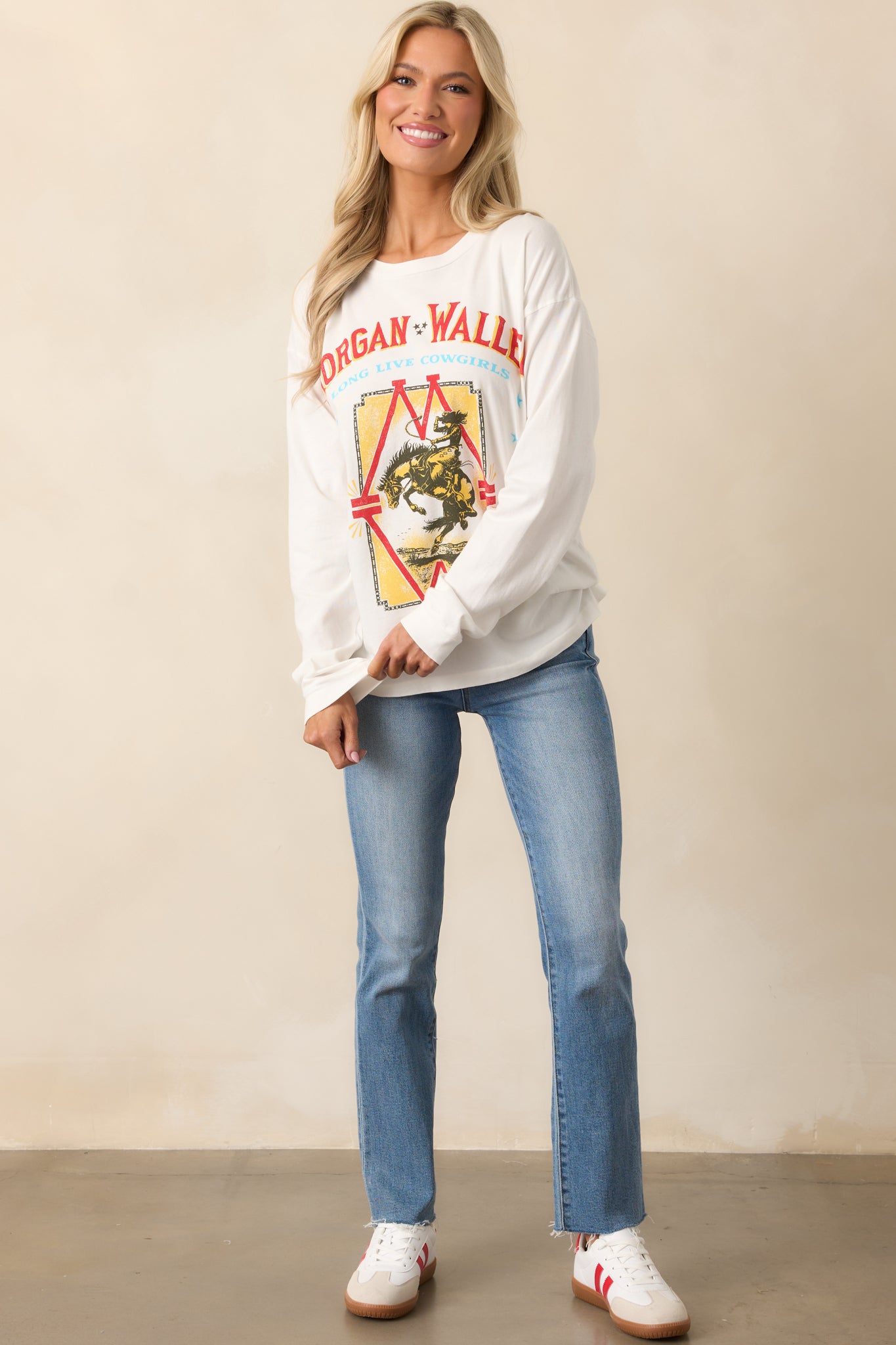 A white long-sleeve tee with a relaxed fit and a bold "Long Live Cowgirls" Morgan Wallen graphic on the front.
