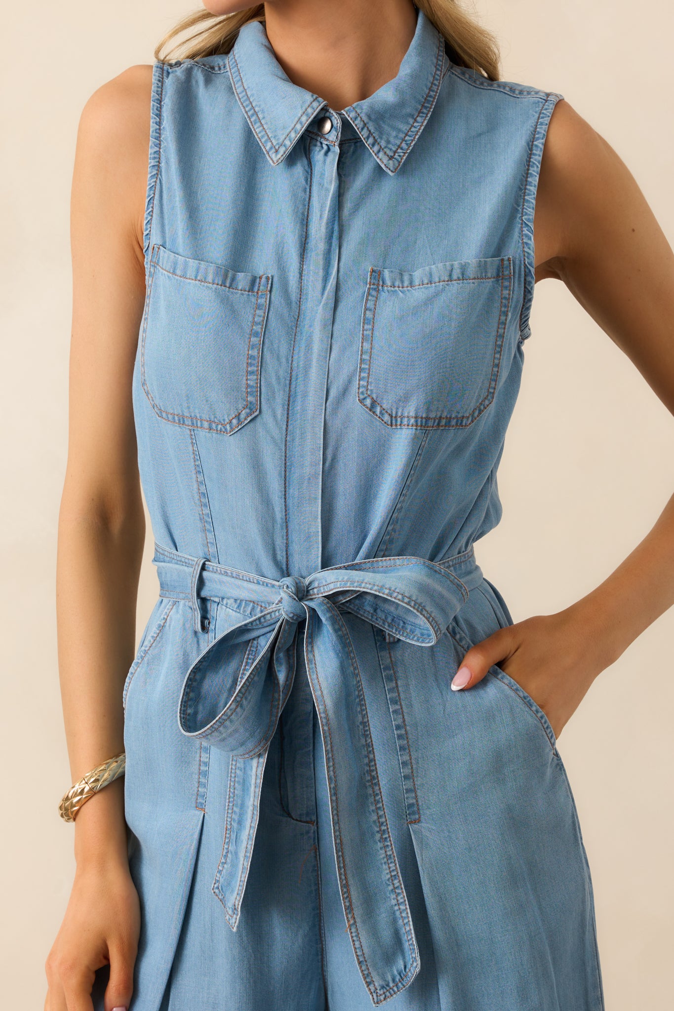 A detailed view of the functional zip front and breast pockets, highlighting the utility-inspired design.