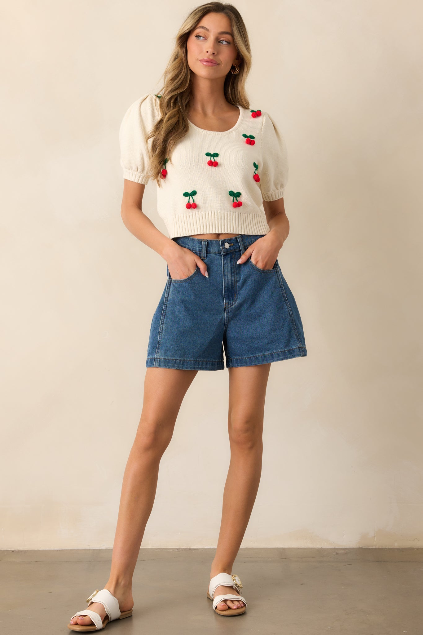 These dark wash shorts are crafted from 100% cotton denim, featuring functional front and back pockets, a classic button and zipper closure, and belt loops for a timeless, versatile style.