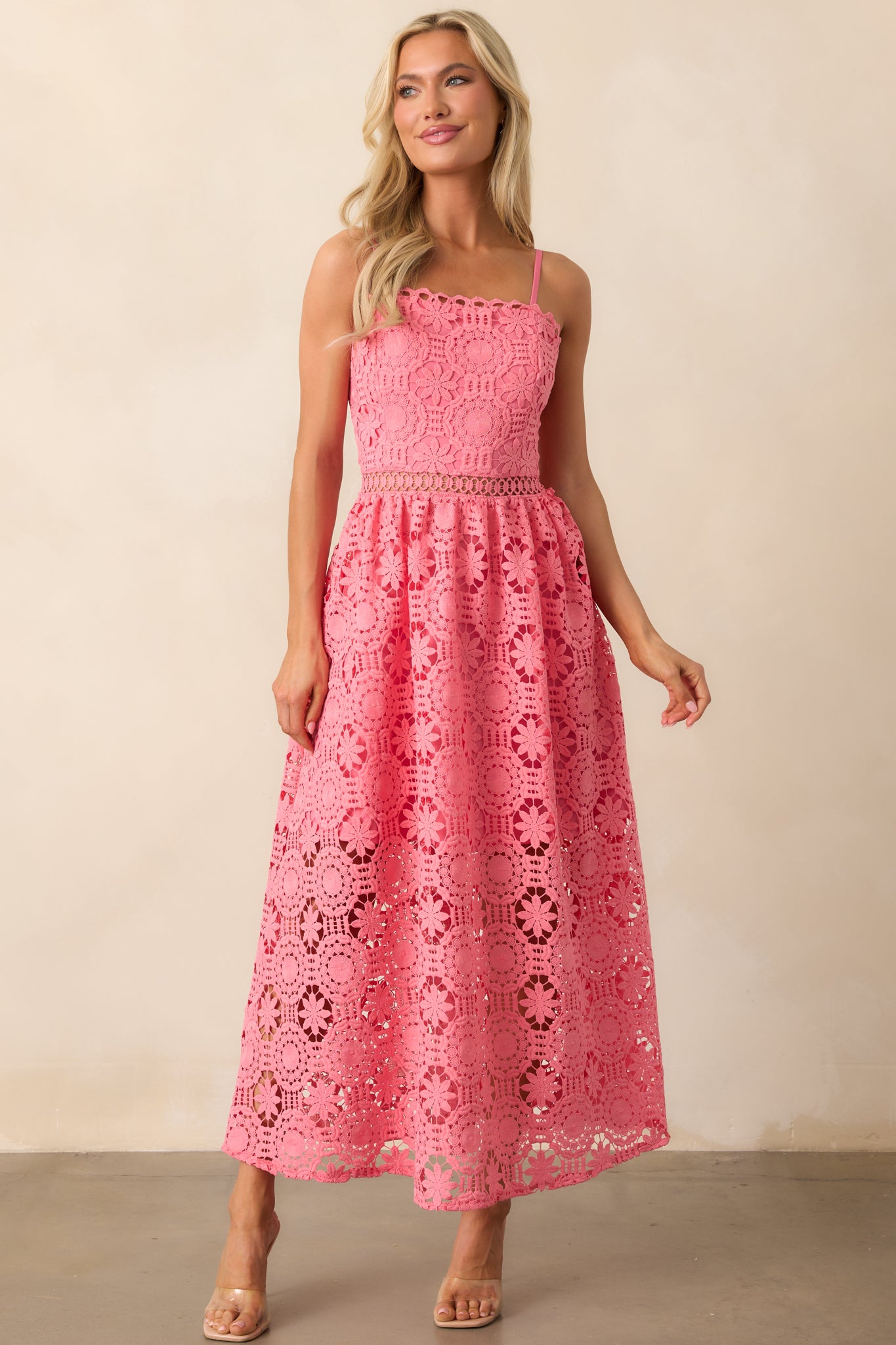 A pink coral dress featuring a floral embroidered overlay, a straight neckline, and adjustable straps for a flattering fit and romantic appeal.