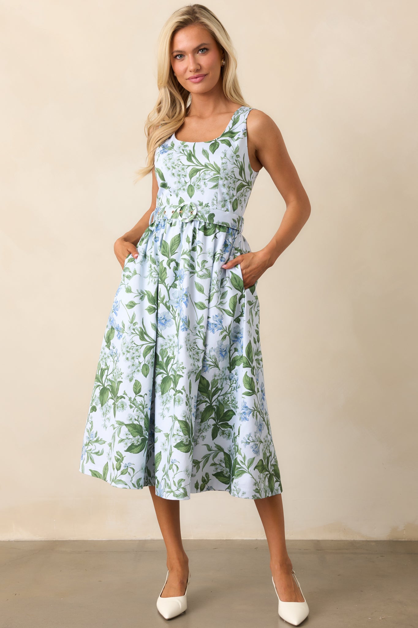 A blue midi dress with a scoop neckline, sleeveless design, and a lilac botanical print for a soft, elegant look.