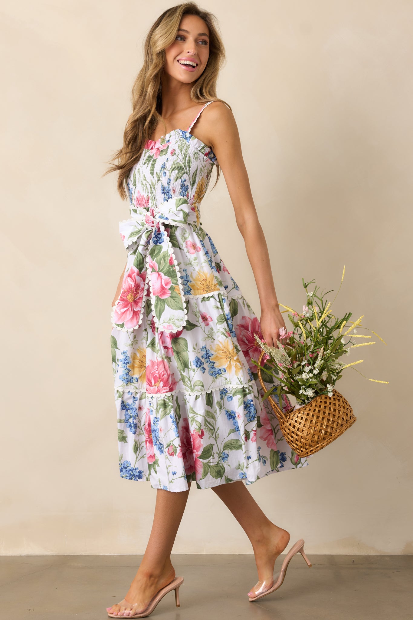 A vibrant floral dress with a multicolor print, ric rac detailing, and a tiered skirt that adds movement and dimension to the silhouette.