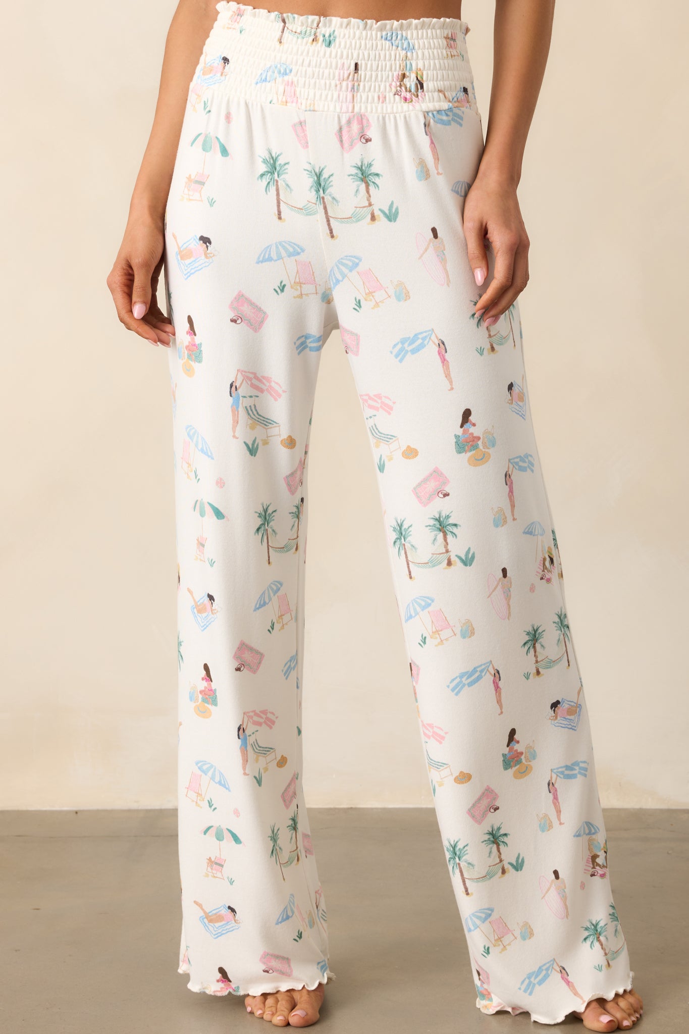 A detailed view of the smocked high-rise waist on these pants, showcasing the beach print and the ultra-soft silky jersey fabric for a comfortable, relaxed fit.