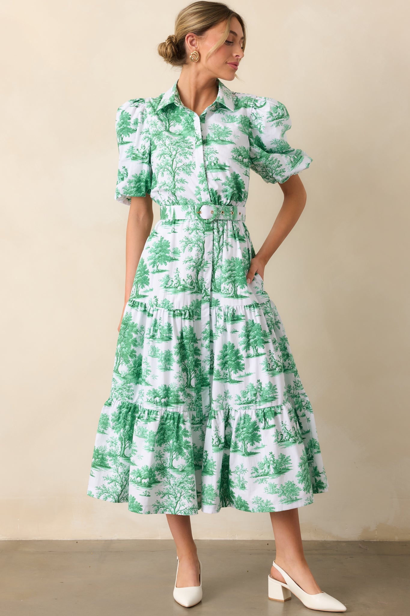 A front-facing view of the eden green toile print dress, showcasing its collared neckline and tiered skirt.