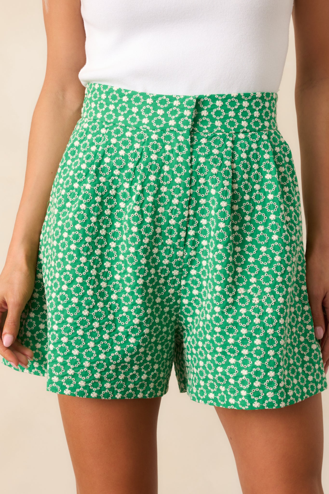 A detailed view of the zipper closure, hook and bar fastening, and functional front pockets of these tailored shorts.